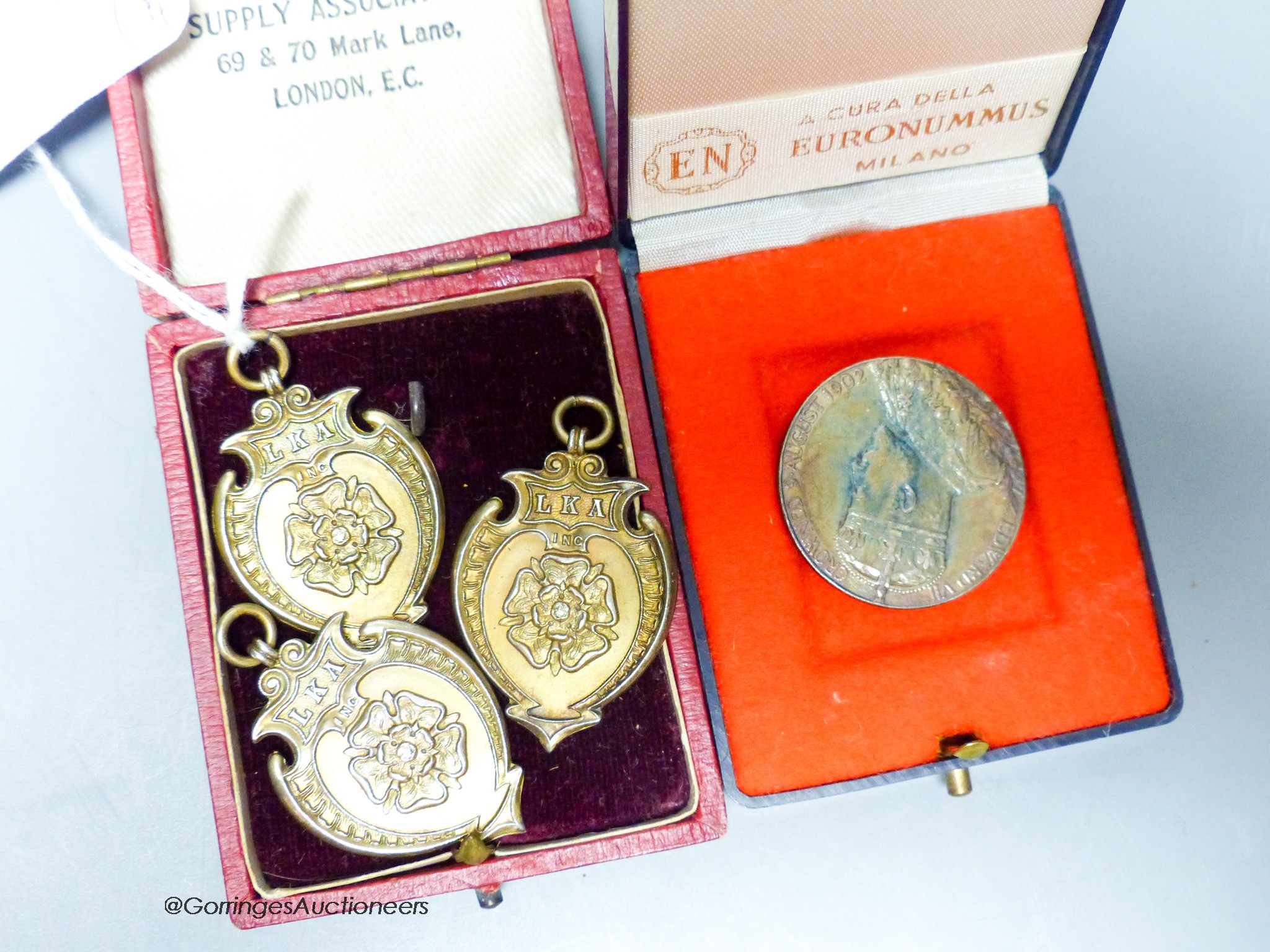 Three silver gilt medals and a George V Coronation medal.